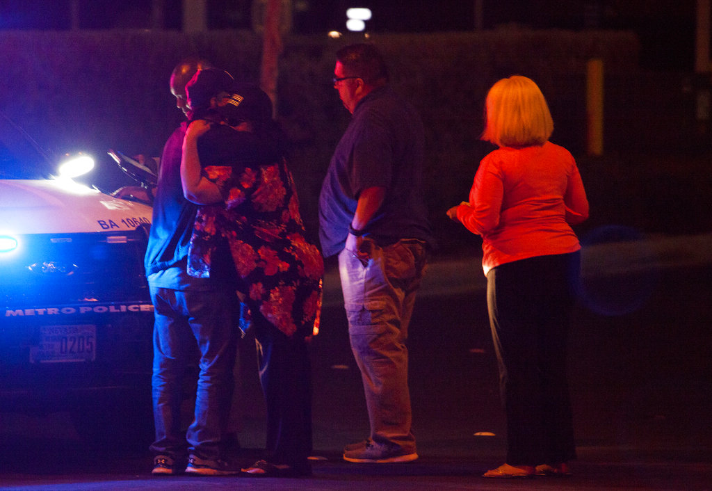 People embrace after arriving at Metro Headquarters to check on loved ones early Monday, Oct. 2, 2017, after a mass shooting at a music festival on the Las Vegas Strip Sunday.