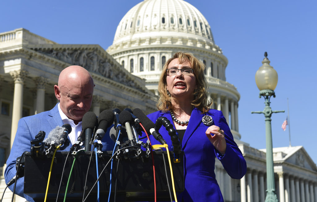 Former Rep. Gabrielle Giffords, D-Ariz., right, standing with her husband Mark Kelly, left, speaks on Capitol Hill in Washington, Monday, Oct. 2, 2017, about the mass shooting in Las Vegas. Giffords, was a congresswoman when she was shot in an assassination attempt in 2011.