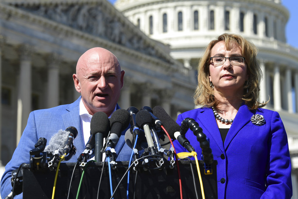 Former Rep. Gabrielle Giffords, D-Ariz., right, listens as her husband Mark Kelly, left, speaks on Capitol Hill in Washington, Monday, Oct. 2, 2017, about the mass shooting in Las Vegas. Giffords, was a congresswoman when she was shot in an assassination attempt in 2011.