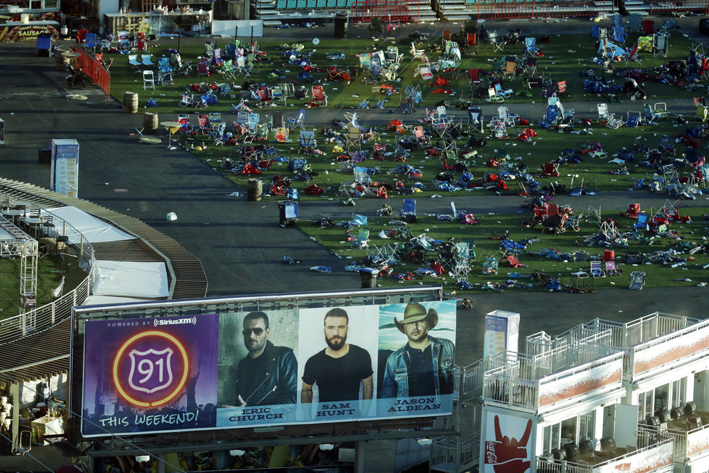 Debris litters a festival grounds across the street from the Mandalay Bay resort and casino Tuesday, Oct. 3, 2017, in Las Vegas. Authorities said Stephen Craig Paddock broke windows on the casino and began firing with a cache of weapons, killing dozens and injuring hundreds at a music festival at the grounds.