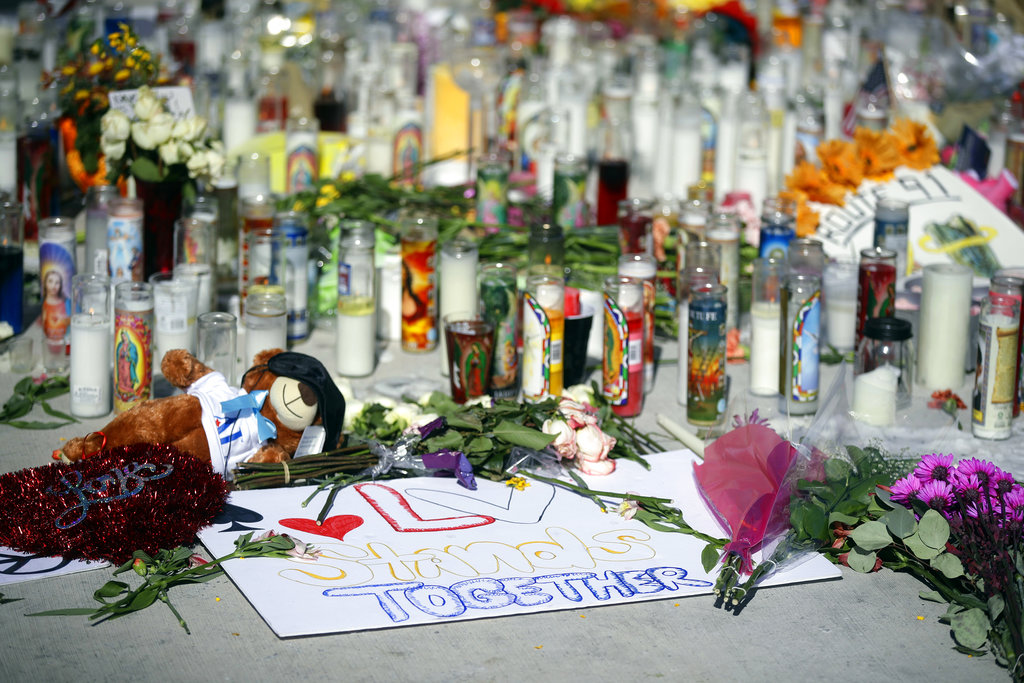 Flowers, candles and toys are left at a makeshift memorial site on Las Vegas Boulevard on Tuesday, Oct. 3, 2017, in Las Vegas. A gunman opened fire on an outdoor music concert on Sunday killing dozens and injuring hundreds.