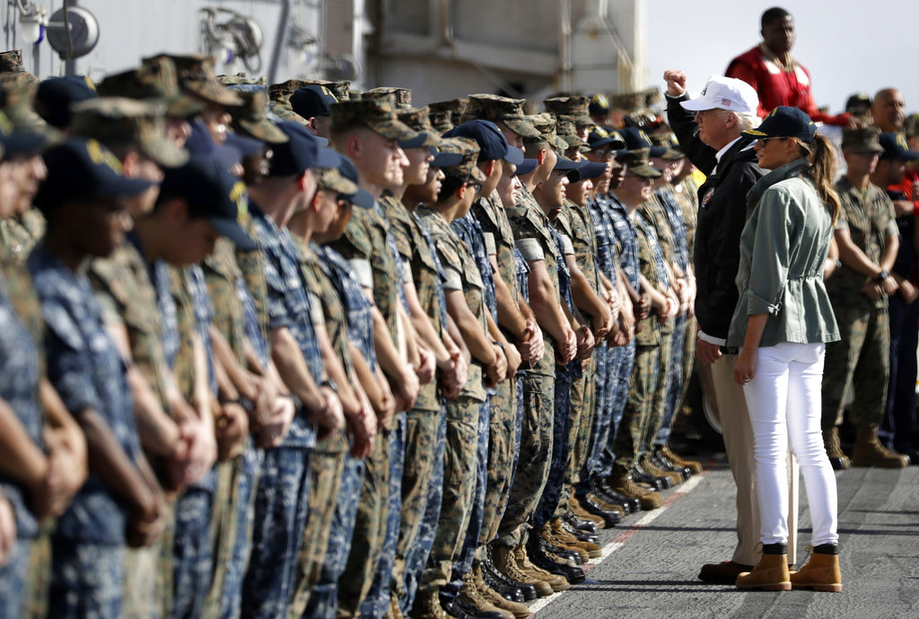 President Donald Trump and first lady Melania Trump greet military members on the USS Kearsarge off the coast of San Juan, Puerto Rico, Tuesday, Oct. 3, 2017.