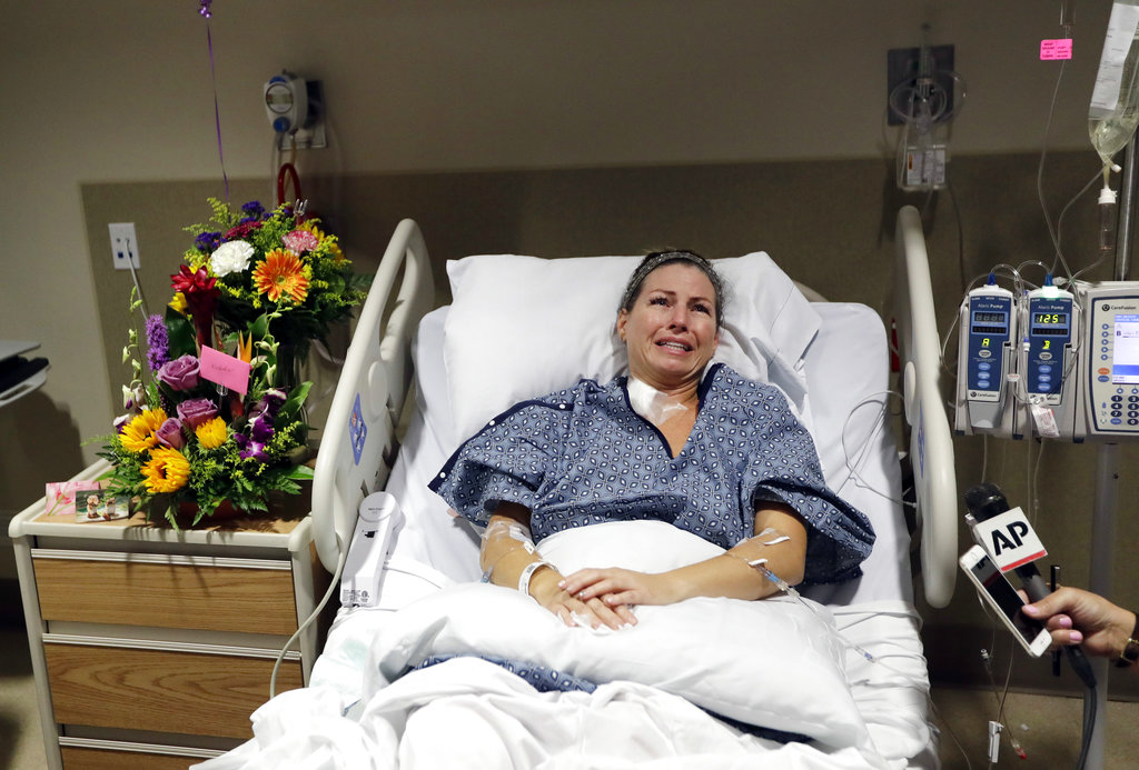 Natalie Vanderstay answers questions from her hospital bed at University Medical Center on Tuesday, Oct. 3, 2017, in Las Vegas. Vanderstay was shot in the stomach and suffered a leg injury after a gunman opened fire on an outdoor music concert on Sunday.