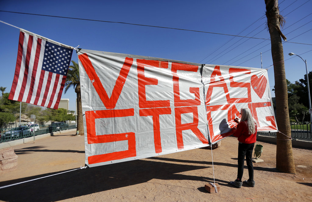 Las Vegas resident Nancy Cooley signs a Vegas Strong banner honoring the victims of a mass shooting on Thursday, Oct. 5, 2017, in Las Vegas. A gunman opened fire on an outdoor music concert on Sunday killing dozens and injuring hundreds.