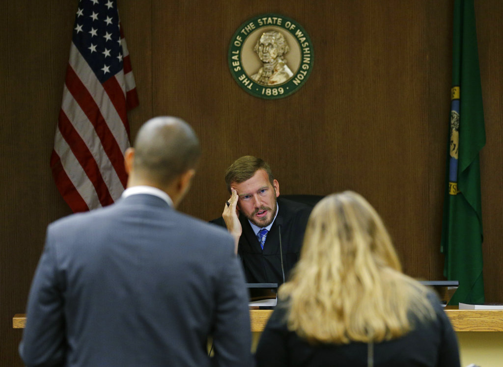 Judge Chris Lanese talks with attorneys during a scheduling hearing in Thurston County Superior Court in Olympia, Wash., for a lawsuit against the Washington Legislature brought by a coalition of news organizations, and led by The Associated Press, on Friday, Oct. 6, 2017.  The suit challenges lawmakers' claim that the state's public records law excludes them from stricter disclosure rules that apply to other elected officials and agencies. (AP Photo/Ted S.