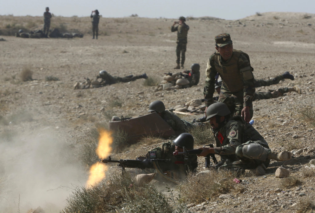 Afghan National Amy commandos open fire during a military exercise in Kabul, Afghanistan, Tuesday, Oct. 17, 2017.