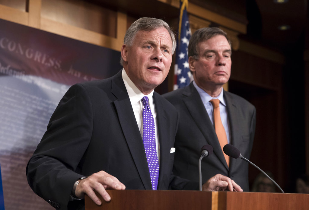 FILE - In this Oct. 4, 2017, file photo, Senate Select Committee on Intelligence Chairman Richard Burr, R-N.C., left, and Vice Chairman Mark Warner, D-Va., update reporters on the status of their inquiry into Russian interference in the 2016 U.S. elections, at the Capitol in Washington. As congressional investigations into Russian interference in the 2016 elections wear on in the Capitol, some lawmakers are starting to wonder when _ and how _ the probes will end. (AP Photo/J.