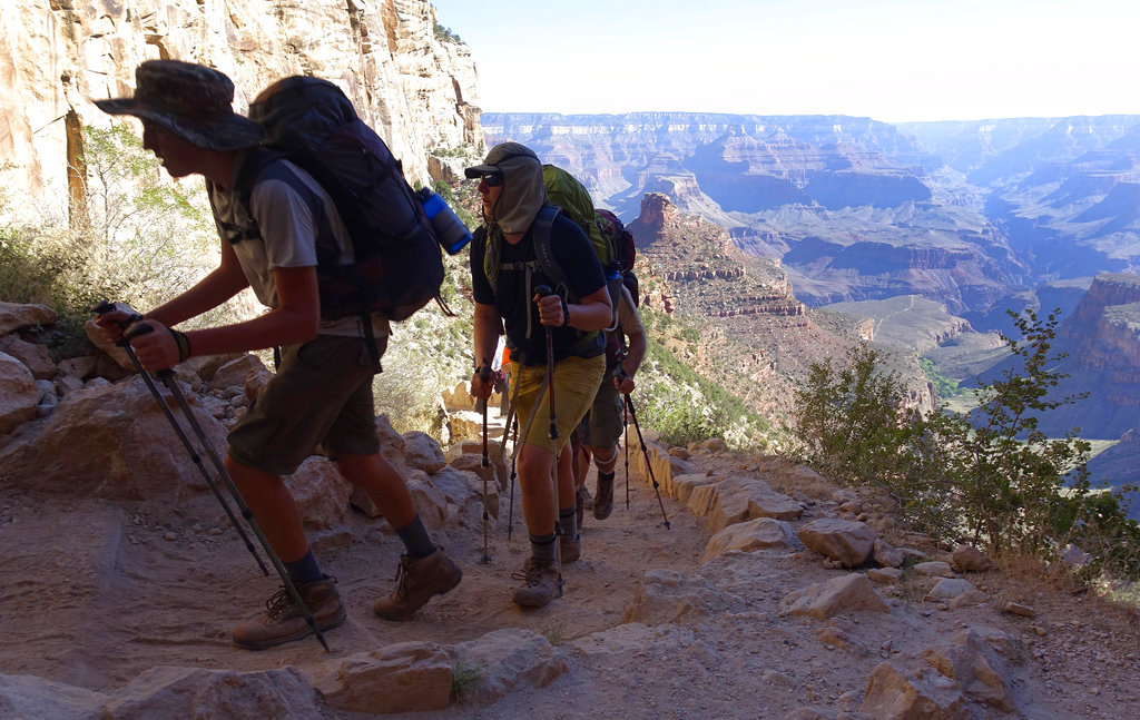FILE - In this July 27, 2015, file photo, a long line of hikers head out of the Grand Canyon along the Bright Angel Trail at Grand Canyon National Park, Ariz. The National Park Service is floating a proposal to increase entrance fees at 17 of its most popular sites next year. (AP Photo/Ross D.