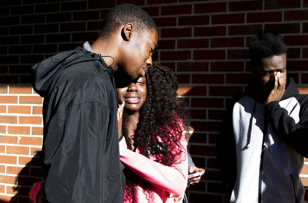 From left, Grambling State University junior Jaylen Hamilton, senior Kyana Manning and junior LeVonte Abbott cry as they stand near the scene of a shooting in Grambling, La., Wednesday, Oct. 25, 2017.  Authorities said a student and his friend were fatally shot after an altercation that began in a dorm room and ended in a courtyard at the historically black university in northern Louisiana.