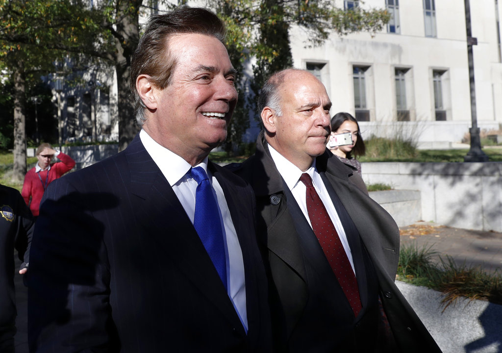 Paul Manafort, left, leaves Federal District Court in Washington, Monday, Oct. 30, 2017. Manafort, President Donald Trump's former campaign chairman, and Manafort's business associate Rick Gates pleaded not guilty to felony charges of conspiracy against the United States and other counts.