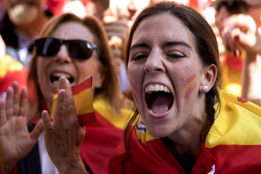 Demonstrators shout slogans as thousands of people march to protest the Catalan government’s push for secession from the rest of Spain in downtown Barcelona, Spain, Sunday.