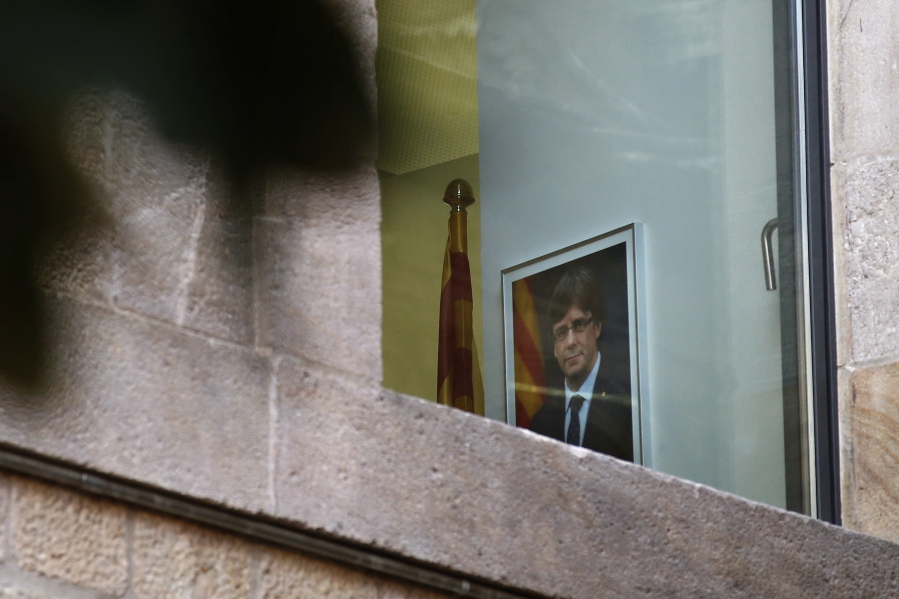 A portrait of ousted regional leader Carles Puigdemont is seen inside the Palau Generalitat in Barcelona, Spain, on Monday. Catalonia’s civil servants face their first full work week since Spain’s central government overturned an independence declaration by firing the region’s elected leaders.