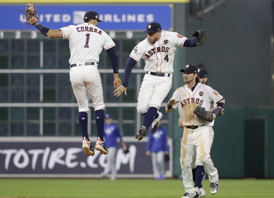Houston Astros’ Carlos Correa and George Springer celebrate Game 3 of baseball’s World Series against the Los Angeles Dodgers Friday, Oct. 27, 2017, in Houston. The Astros won 5-3 to take a 2-1 lead in the series. (AP Photo/David J.
