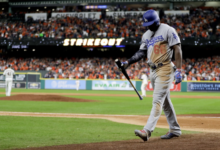 Los Angeles Dodgers’ Yasiel Puig walks to the dugout after striking out against the Houston Astros during the ninth inning of Game 3 of baseball’s World Series Friday, Oct. 27, 2017, in Houston.