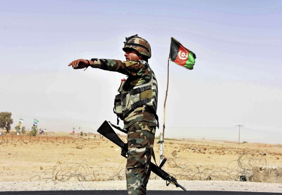 An Afghan National Army soldier directs a vehicle to stop at a checkpoint on the way to Zhari district, where the Maiwand army base is located, in Kandahar, Afghanistan, Thursday, Oct. 19, 2017. The Taliban have killed at least 58 Afghan security forces in a wave of attacks across the country, including an assault that nearly wiped out the Maiwand camp in the southern Kandahar province.