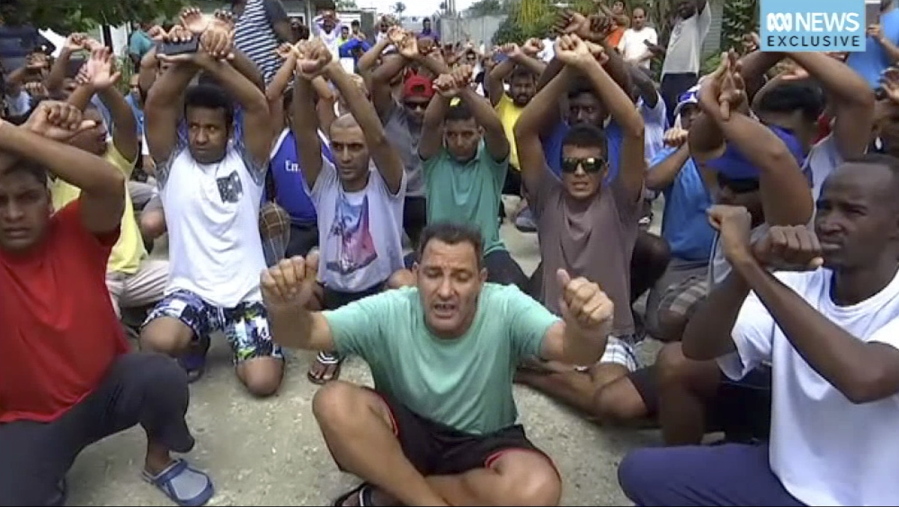 In this photo made from Australia Broadcasting Coporation video made on Tuesday asylum seekers protesting the possible closure of their detention center, on Manus Island, Paua New Guinea. Lawyers for 606 asylum seekers in an Australian offshore detention center on Papua New Guinea’s Manus Island sought a court injunction to prevent the facility’s scheduled closure, as fears mounted of violent confrontations with locals who oppose the asylum seekers living among them.