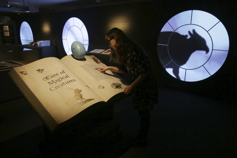A member of British Library staff poses for a picture at the “Harry Potter — A History of Magic” exhibition at the British Library in London.
