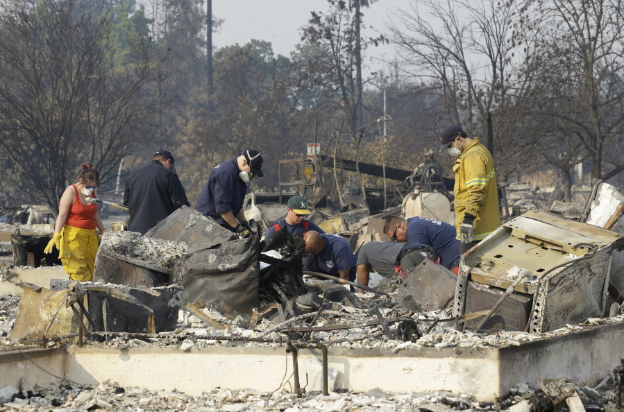 Authorities sift through the burned area of a home as they search for victims at Coffey Park area of Santa Rosa, Calif., on Monday.