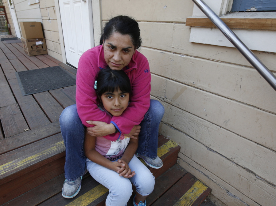 Wilma Illanes and her daughter Gabriela Cervantes, 8, pose Wednesday, Oct. 18, 2017, in Sonoma, Calif. Illanes and her family had to evacuate from there home as a massive wildfire swept through the area last week. While their home was sparred, Illanes, who is a baby sitter, and her husband, who is a landscaper, were both out of work for a work causing them to seek assistance due to the hardship.