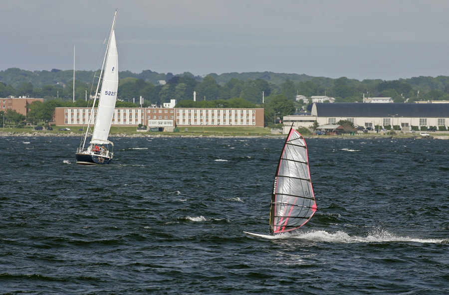 FILE - In this June 12, 2007, file photo, a windsurfer and people aboard a sailboat enjoy the strong winds of Narragansett Bay off the coast of Newport, R.I. The Environmental Protection Agency has canceled the appearance of three scientists at an event on Monday, Oct. 23, 2017, in Rhode Island about a report, which deals in part with climate change. The event is designed to draw attention to the health of the Narragansett Bay.