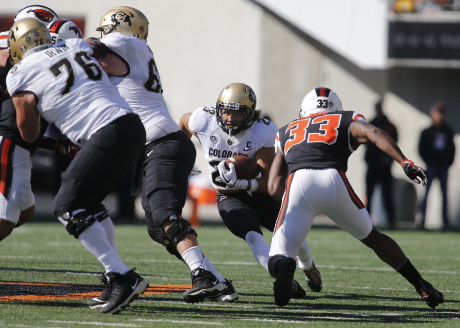 Colorado running back Phillip Lindsay (23) looks for an opening in the Oregon State defense during the first half an NCAA college football game, in Corvallis, Ore., Saturday, Oct. 14, 2017. (AP Photo/Timothy J.
