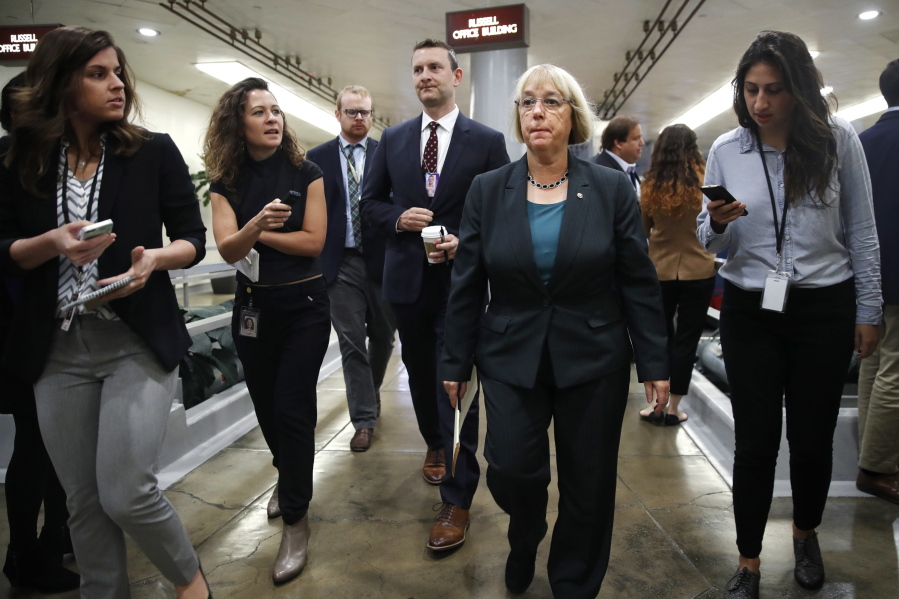 Sen. Patty Murray, D-Wash., second from right, is surrounded by reporters as she heads to vote on budget amendments, Thursday, Oct. 19, 2017, in Washington.