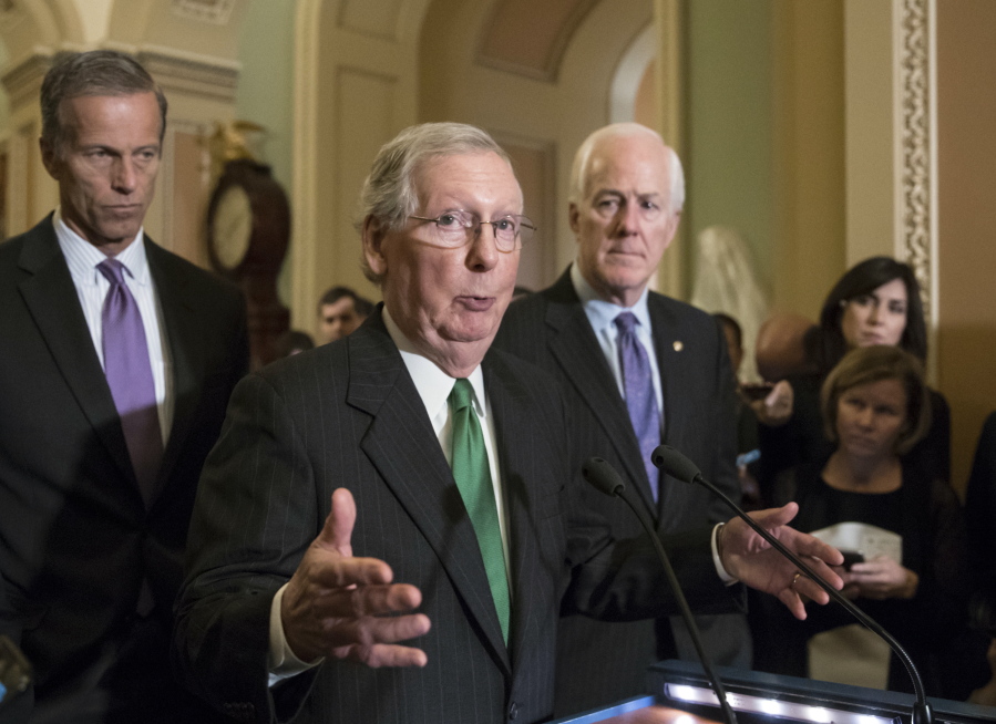 In this Oct. 17, 2017, photo, Senate Majority Leader Mitch McConnell, R-Ky., flanked by Sen. John Thune, R-S.D., left, and Majority Whip John Cornyn, R-Texas, announces to reporters that the Senate is moving ahead on a Republican budget plan at the Capitol in Washington. Senate Republicans seem to be on cruise control to pass a $4 trillion budget plan that shelves GOP deficit concerns in favor of the party’s drive to cut taxes. (AP Photo/J.