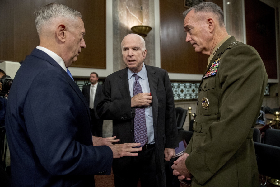 Defense Secretary Jim Mattis, left, and Joint Chiefs Chairman Gen. Joseph Dunford, right, speak with Chairman Sen. John McCain, R-Ariz., center, as they arrive to testify on Afghanistan before the Senate Armed Services Committee on Capitol Hill in Washington, Tuesday, Oct. 3, 2017.