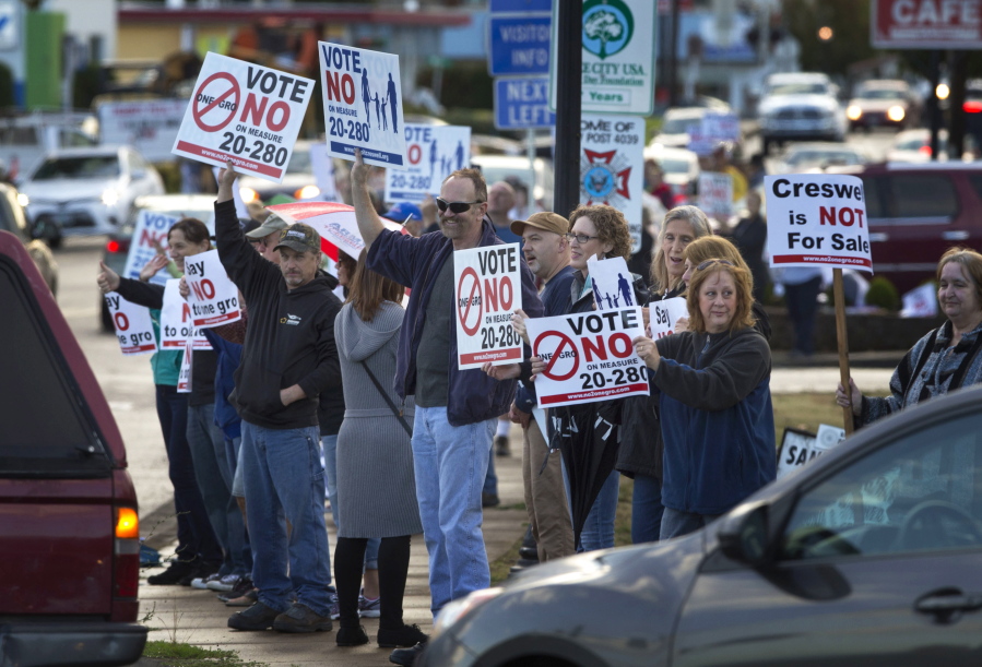 Protesters line Oregon Avenue near Interstate 5 in Creswell, Ore., during the evening commute Monday.