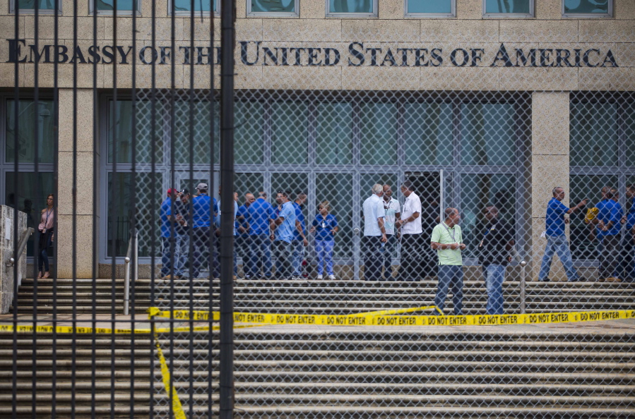 In a Friday, Sept. 29, 2017 file photo, staff stand within the United States embassy facility in Havana, Cuba. The terrifying attacks in Cuba overwhelmingly hit U.S. intelligence operatives in Havana, not ordinary diplomats, when they began within days of President Donald Trump’s election, The Associated Press has learned. To date, the Trump administration largely described the victims as U.S. Embassy personnel or “members of the diplomatic community,” suggesting it was bona fide diplomats who were hit. That spies, working under diplomatic cover, comprised the majority of the early victims adds an entirely new element of mystery to what’s harmed at least 21 Americans over the last year.