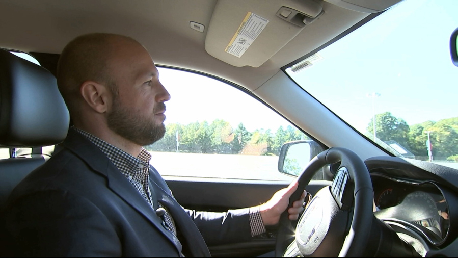In this image from video, Jake Nelson, AAA’s director for traffic safety advocacy and research drives one of the test vehicles used in the study in Washington, Wednesday, Oct. 4, 2017. Infotainment technology automakers are cramming into the dashboard of new vehicles is making drivers take their eyes off the road and hands off the wheel for dangerously long periods of time, a study being released by AAA on Oct. 5 says.