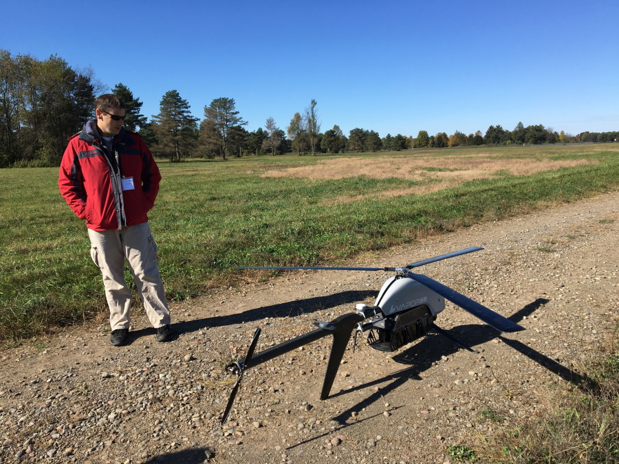 Nick Brown, a drone pilot for Pulse Aerospace of Lawrence, Kan., stands beside a Pulse Vapor unmanned aircraft at Griffiss International Airport in Rome, N.Y.