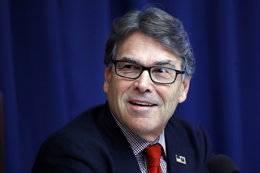 Energy Secretary Rick Perry attends a news conference July 18 at the National Press Club in Washington. The Energy Department says Perry has taken at least six trips on government or private planes costing an estimated $56,000.