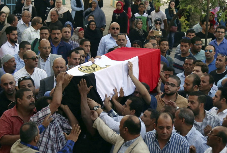 People carry the coffin, covered with the an Egyptian flag, of police captain Ahmed Fayez who was killed in a gun battle in al-Wahat al-Bahriya area in Giza province, about 135 kilometers (84 miles) southwest of Cairo, during his funeral at Al-Hosary mosque, in Cairo, Egypt, Saturday, Oct. 21, 2017. At least 54 policemen, including 20 officers and 34 conscripts, were killed when a raid on a militant hideout southwest of Cairo escalated into an all-out firefight, authorities said Saturday, in one of the single deadliest attacks by militants against Egyptian security forces in recent years.
