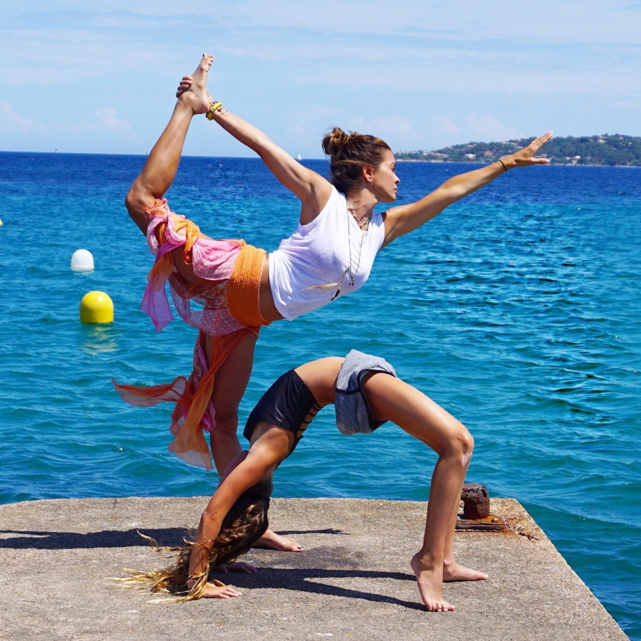 This undated photo provided by Brooke Burke Charvet shows Charvet doing yoga with her daughter Rain in Malibu, Calif.