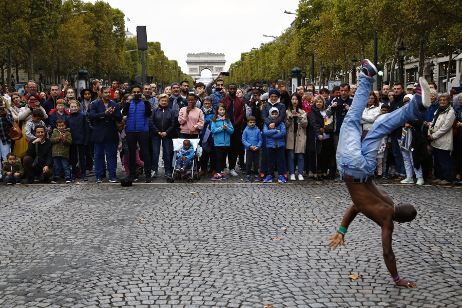 People watch a dancer on the Champs Elysees on Oct. 1 during the “day without cars” in Paris.