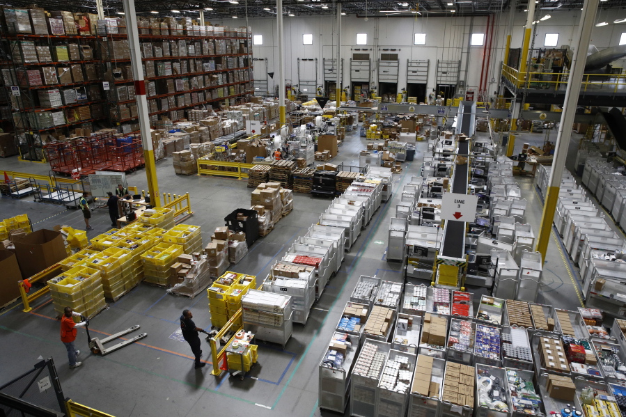 Workers prepare to move products at an Amazon fulfillment center in Baltimore.