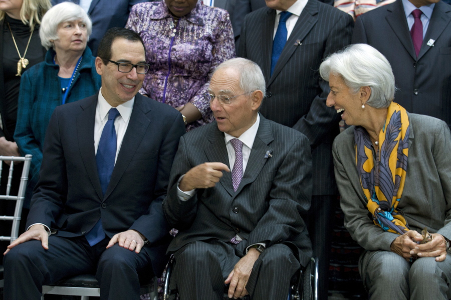 From left, U.S. Treasury Secretary Steven Mnuchin, Germany Finance Minister Wolfgang Schäuble, and International Monetary Fund (IMF) Managing Director Christine Lagarde speak during the Monetary Fund (IMF) Governors group photo during World Bank/IMF annual meetings in Washington, Saturday, Oct. 14, 2017. At background left is U.S Federal Reserve Chair Janet Yellen.