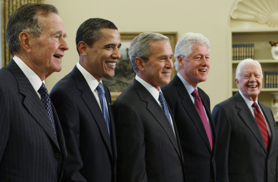 FILE - In this Jan. 7, 2009 file photo, Then-President George W. Bush, center, poses with President-elect Barack Obama, and former presidents, from left, George H.W. Bush, left, Bill Clinton and Jimmy Carter, right, in the Oval Office of the White House in Washington. All five living former U.S. presidents will be attending a concert Saturday night, Oct. 21, 2017, in a Texas college town, raising money for relief efforts from Hurricane Harvey, Irma and Maria's devastation in Texas, Florida, Puerto Rico and the U.S. Virgin Islands. (AP Photo/J.