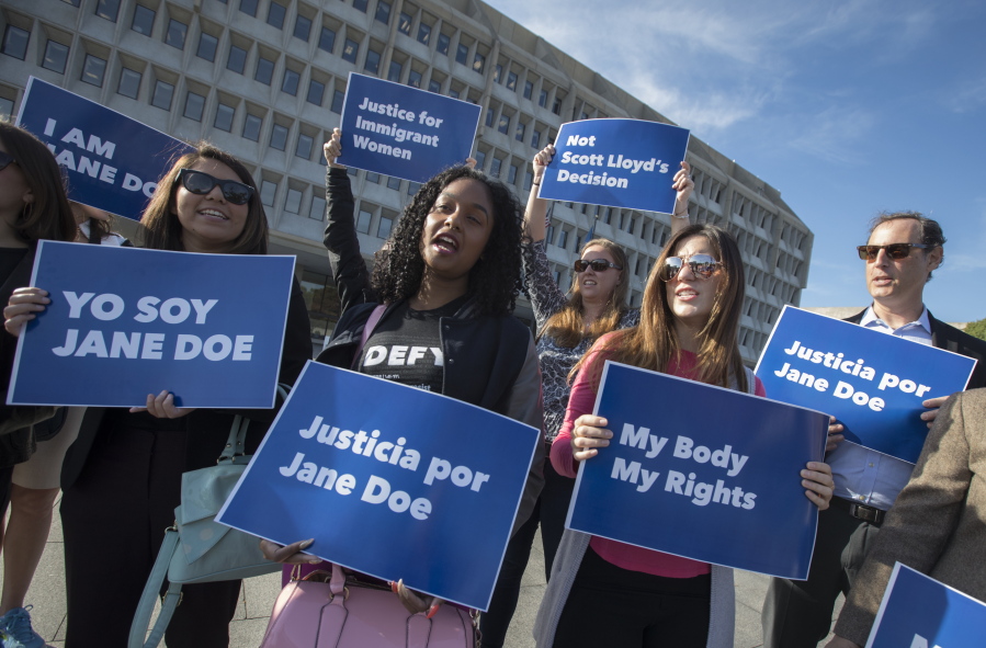 Activists with Planned Parenthood demonstrate in support of a pregnant 17-year-old being held in a Texas facility for unaccompanied immigrant children to obtain an abortion, outside of the Department of Health and Human Services in Washington, Friday, Oct. 20, 2017. (AP Photo/J.