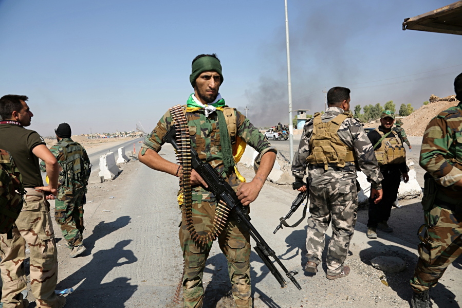 Iraqi security forces and Popular Mobilization Forces patrol in Tuz Khormato, that was evacuated by Kurdish security forces, 130 miles north of Baghdad, Iraq, on Monday. Two weeks after fighting together against the Islamic State, Iraqi forces pushed their Kurdish allies out of the disputed city of Kirkuk on Monday, seizing oil fields and other facilities amid soaring tensions over last month’s Kurdish vote for independence.