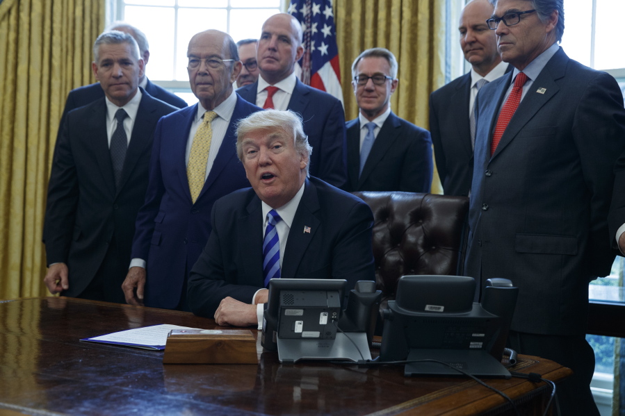 President Donald Trump announces the approval of a permit to build the Keystone XL pipeline on March 24, clearing the way for the $8 billion project, in the Oval Office of the White House in Washington.
