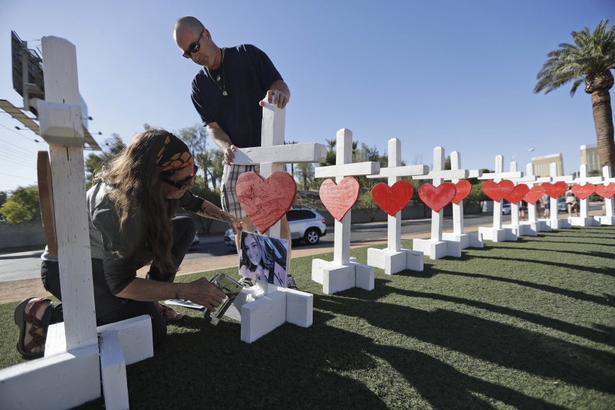 Sherri Camperchioli, left, and Jordan Cassel help set up crosses that arrived in Las Vegas Thursday to honor the victims of the mass shooting.