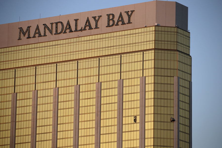 Drapes billow out of broken windows Oct. 2 at the Mandalay Bay resort and casino on the Las Vegas Strip, following a deadly shooting at a music festival in Las Vegas. Two hotel employees had called for help and reported that gunman Stephen Paddock sprayed a hallway with bullets, striking an unarmed security guard in the leg, several minutes before Paddock opened fire from the resort on a crowd below at a musical performance, killing dozens of people and injuring hundreds.
