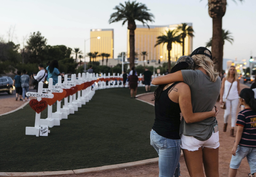 A memorial displaying 58 crosses by Greg Zanis stands at the Welcome To Las Vegas Sign on Thursday, October 5, 2017, in Las Vegas. Each cross has the name of a victim killed during the mass shooting at the Route 91 Harvest country music festival this past Sunday. Dozens of people were killed and hundreds were injured.