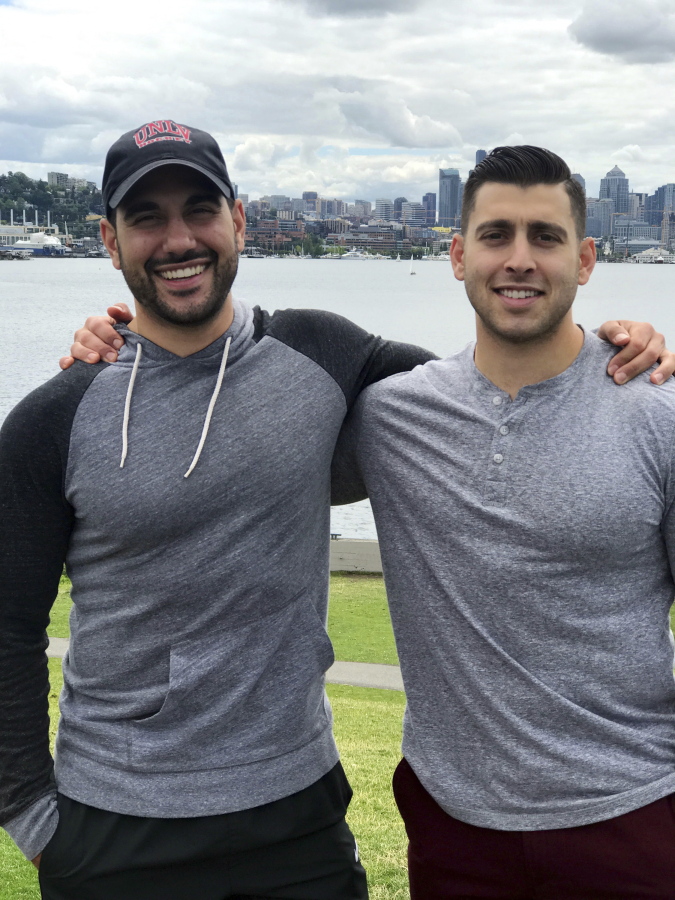 Nicholas Robone, 28, left, and his brother, Anthony, 25, are seen in this 2017 photo during a trip to Seattle. The brothers grew up close in Las Vegas, where they were the only siblings in the same family and shared a love of hockey and the same alma mater, the University of Nevada, Las Vegas. Tony grew up to be a firefighter and paramedic and has been credited with saving the life of his brother, who he was with when he was shot in the upper chest on Oct. 1 at a country music festival during the deadliest mass shooting in modern U.S. history. Nick is expected to make a full recovery and be ready to return to work in six to eight weeks.