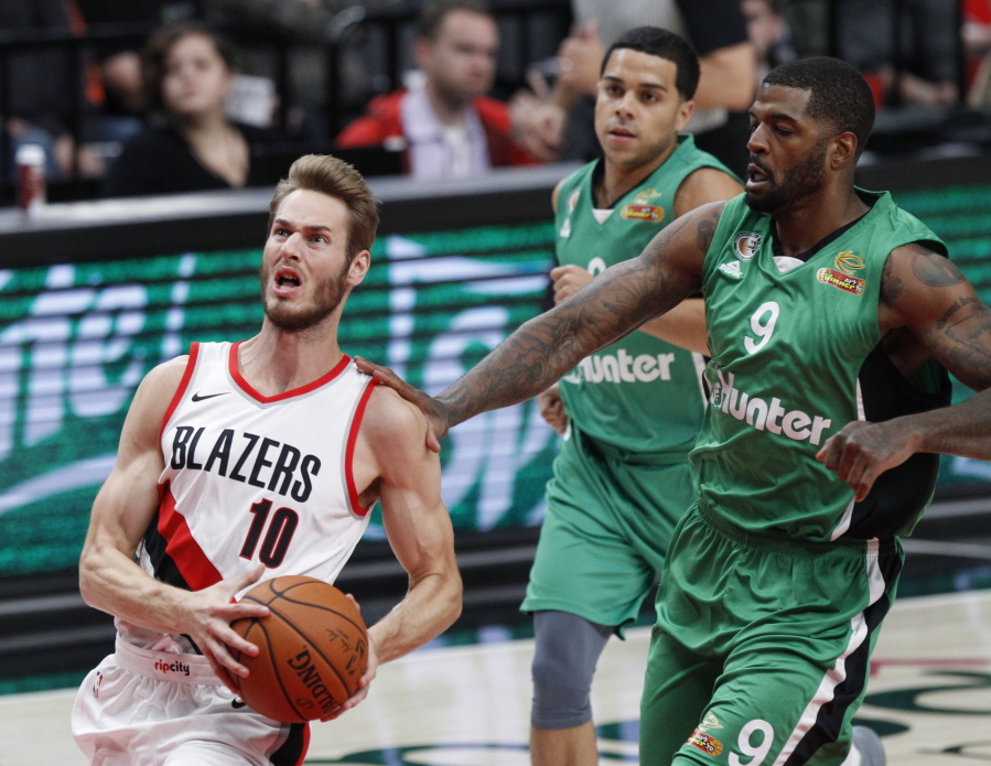Portland Trail Blazers forward Jake Layman, left, drives to the basket as Maccabi Haifa forward Josh Smith defends during the first half of an NBA exhibition basketball game in Portland, Ore., Friday, Oct. 13, 2017.