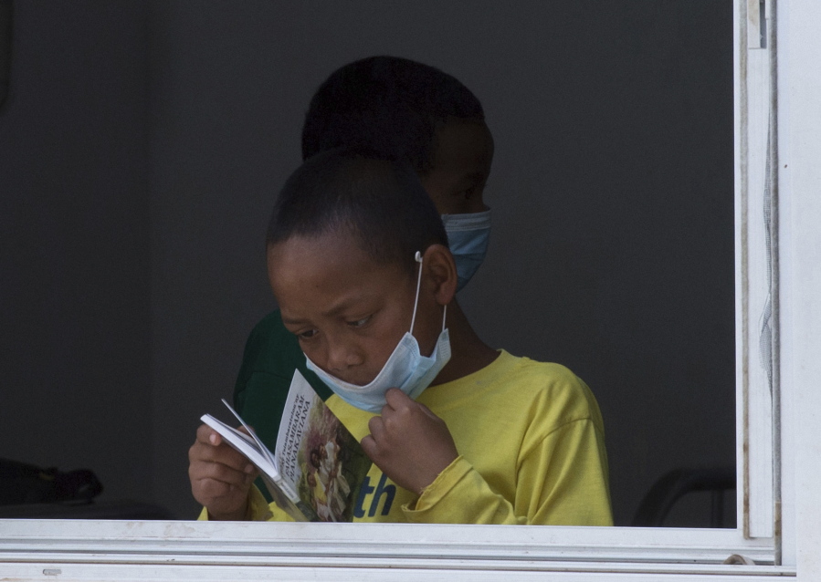 A girl wears a face mask inside a hospital in the capital Antananarivo, Madagascar. A plague outbreak has brought some panic to the city dwellers with schools closed and public gatherings banned as the death toll still mounts in the Indian Ocean island nation.