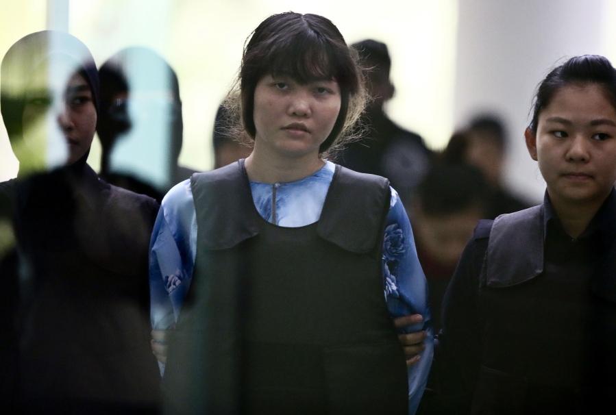 Vietnamese Doan Thi Huong, center, is escorted by police officers as she arrives for a court hearing at Shah Alam court house in Shah Alam, outside Kuala Lumpur, Malaysia, Thursday. Security camera videos showed Wednesday Kim Jong Nam, the estranged half brother of North Korea’s leader, being attacked at a Malaysian airport and the two suspects, including Doan, hurrying away afterward have been presented at their murder trial.