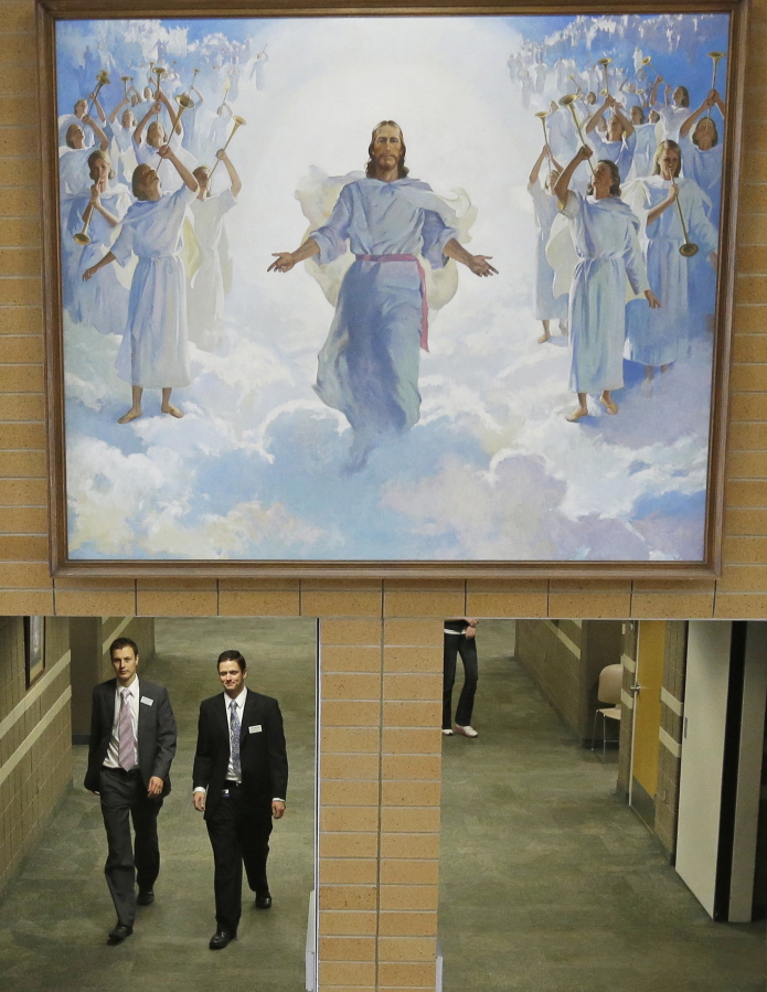 FILE - In this Jan. 8, 2013, file photo, people walk through the halls at the Missionary Training Center in Provo, Utah. The Mormon church’s gradual embrace of the digital age for missionaries is taking another step forward as the religion doubles the missions where technology is allowed and swaps out tablets for smartphones.